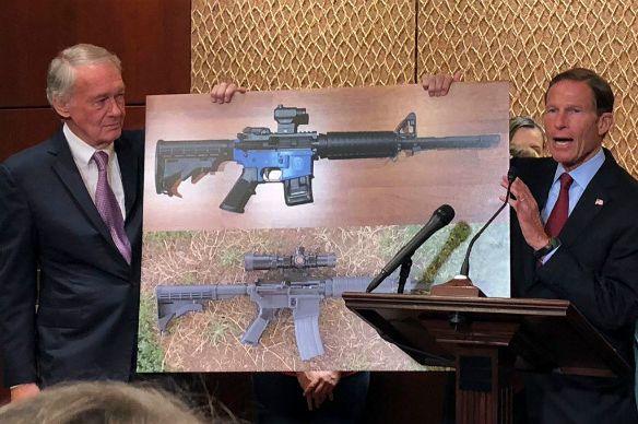 Sen. Edward Markey and Sen. Richard Blumenthal display a photo of a plastic gun, on Capitol Hill in Washington